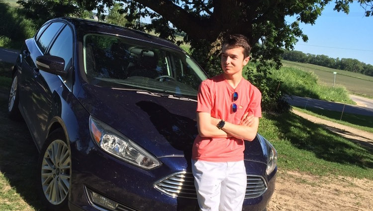 Photo of Logan with car