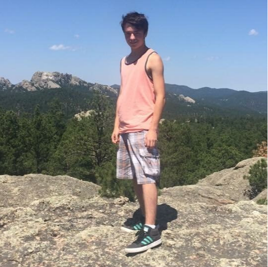 Photo of Logan climbing mountain
